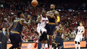 May 20, 2015; Atlanta, GA, USA; Atlanta Hawks forward DeMarre Carroll (5) drives to the basket against Cleveland Cavaliers guard Iman Shumpert (4) and forward LeBron James (23) during the fourth quarter of game one of the Eastern Conference Finals of the NBA Playoffs at Philips Arena. Carroll was injured on the play. Mandatory Credit: Dale Zanine-USA TODAY Sports