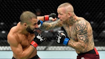 CALGARY, AB - JULY 28: (R-L) Ross Pearson of England punches John Makdessi of Canada in their lightweight bout during the UFC Fight Night event at Scotiabank Saddledome on July 28, 2018 in Calgary, Alberta, Canada. (Photo by Jeff Bottari/Zuffa LLC/Zuffa LLC via Getty Images)