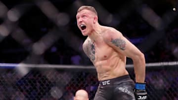 Mar 30, 2019; Philadelphia, PA, USA; Jack Hermansson (blue gloves) celebrates his win over David Branch (red gloves) during UFC Fight Night at Wells Fargo Arena. Hermansson won the fight. Mandatory Credit: Bill Streicher-USA TODAY Sports