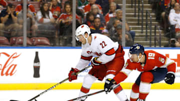 SUNRISE, FLORIDA - OCTOBER 08: Brett Pesce #22 of the Carolina Hurricanes battles for control of the puck with Mike Matheson #19 of the Florida Panthers during the second period at BB&T Center on October 08, 2019 in Sunrise, Florida. (Photo by Michael Reaves/Getty Images)