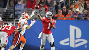 GLENDALE, ARIZONA - DECEMBER 28: Justin Fields #1 of the Ohio State Buckeyes attempts a pass under pressure from Logan Rudolph #34 of the Clemson Tigers in the first half during the College Football Playoff Semifinal at the PlayStation Fiesta Bowl at State Farm Stadium on December 28, 2019 in Glendale, Arizona. (Photo by Christian Petersen/Getty Images)