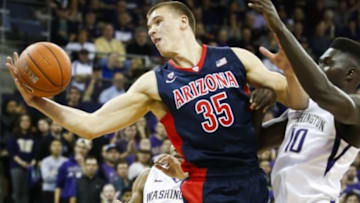 Feb 6, 2016; Seattle, WA, USA; Arizona Wildcats center Kaleb Tarczewski (35) grabs a rebound in front of Washington Huskies forward Malik Dime (10) during the first half at Alaska Airlines Arena. Mandatory Credit: Jennifer Buchanan-USA TODAY Sports