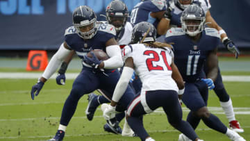 NASHVILLE, TENNESSEE - OCTOBER 18: Running back Derrick Henry #22 of the Tennessee Titans runs with the ball against Bradley Roby #21 of the Houston Texans in the first quarter at Nissan Stadium on October 18, 2020 in Nashville, Tennessee. (Photo by Frederick Breedon/Getty Images)
