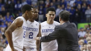 Dec 5, 2014; Lexington, KY, USA; Kentucky Wildcats head coach John Calipari (R) talks with guard Andrew Harrison (5), guard Aaron Harrison (2), and guard Devin Booker (1) during the game against the Texas Longhorns in the second half at Rupp Arena. The Wildcats won 63-51. Mandatory Credit: Mark Zerof-USA TODAY Sports