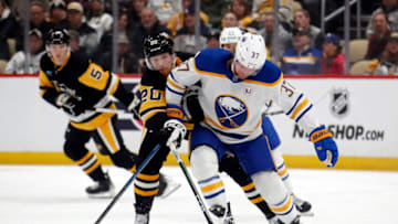 Nov 11, 2023; Pittsburgh, Pennsylvania, USA; Buffalo Sabres center Casey Mittelstadt (37) chases the puck against pressure from Pittsburgh Penguins center Lars Eller (20) during the first period at PPG Paints Arena. Mandatory Credit: Charles LeClaire-USA TODAY Sports
