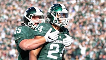 Oct 8, 2016; East Lansing, MI, USA; Michigan State Spartans running back Gerald Holmes (24) and Michigan State Spartans fullback Prescott Line (45) celebrate a touchdown during the 1st quarter of a game against the Brigham Young Cougars at Spartan Stadium. Mandatory Credit: Mike Carter-USA TODAY Sports