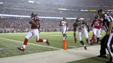 Sep 18, 2014; Atlanta, GA, USA; Atlanta Falcons running back Antone Smith (35) scores a touchdown past Tampa Bay Buccaneers strong safety Mark Barron (23) and Tampa Bay Buccaneers cornerback Alterraun Verner (21) in the third quarter of their game at the Georgia Dome. The Falcons won 56-14. Mandatory Credit: Jason Getz-USA TODAY Sports