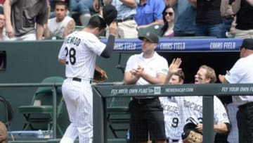 May 18, 2014; Denver, CO, USA; Colorado Rockies third baseman Nolan Arenado (28) tips his hat to the crowd after turning a triple play in the third inning against the San Diego Padres at Coors Field. Mandatory Credit: Ron Chenoy-USA TODAY Sports