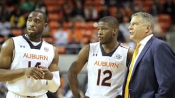 Nov 14, 2014; Auburn, AL, USA; Auburn Tigers guard Antoine Mason (14) and guard KC Ross-Miller (12) talk to head coach Bruce Pearl during a break in the action against the Milwaukee Panthers during the second half at Auburn Arena. The Tigers beat the Panthers 83-73. Mandatory Credit: John Reed-USA TODAY Sports