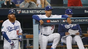 LOS ANGELES, CA - OCTOBER 27: Justin Turner #10 and manager Dave Roberts #30 of the Los Angeles Dodgers look on from the dugout in the ninth inning of Game Four of the 2018 World Series against the Boston Red Sox at Dodger Stadium on October 27, 2018 in Los Angeles, California. The Red Sox defeated the Dodgers 9-6. (Photo by Sean M. Haffey/Getty Images)