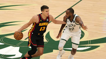MILWAUKEE, WISCONSIN - JUNE 25: Khris Middleton #22 of the Milwaukee Bucks defends against Bogdan Bogdanovic #13 of the Atlanta Hawks during the second half in game two of the Eastern Conference Finals at Fiserv Forum on June 25, 2021 in Milwaukee, Wisconsin. NOTE TO USER: User expressly acknowledges and agrees that, by downloading and or using this photograph, User is consenting to the terms and conditions of the Getty Images License Agreement. (Photo by Stacy Revere/Getty Images)