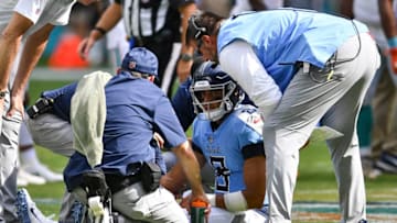 MIAMI, FL - SEPTEMBER 09: Titans medical staff and head coach Mike Vrabel checking on Marcus Mariota #8 of the Tennessee Titans during the third quarter against the Miami Dolphins at Hard Rock Stadium on September 9, 2018 in Miami, Florida. (Photo by Mark Brown/Getty Images)