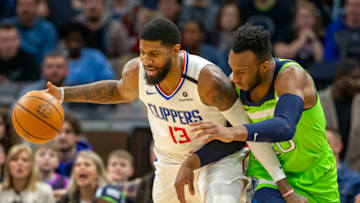 Feb 8, 2020; Minneapolis, Minnesota, USA; LA Clippers forward Paul George (13) handles the ball against Minnesota Timberwolves guard Josh Okogie (20) in the first half at Target Center. Mandatory Credit: Jesse Johnson-USA TODAY Sports