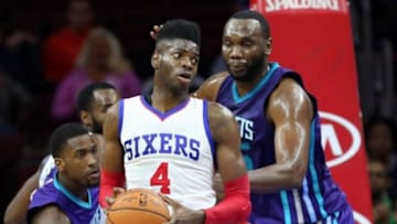Oct 8, 2014; Philadelphia, PA, USA; Philadelphia 76ers forward Nerlens Noel (4) attempts to drive against Charlotte Hornets center Al Jefferson (25) during the first half at the Wells Fargo Center. Mandatory Credit: Bill Streicher-USA TODAY Sports