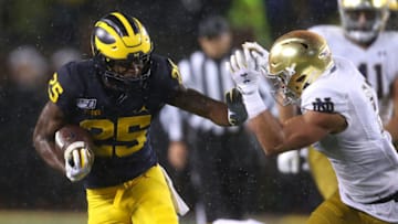 ANN ARBOR, MICHIGAN - OCTOBER 26: Hassan Haskins #25 of the Michigan Wolverines tries to get around the tackle of Alohi Gilman #11 of the Notre Dame Fighting Irish during a first half run at Michigan Stadium on October 26, 2019 in Ann Arbor, Michigan. (Photo by Gregory Shamus/Getty Images)