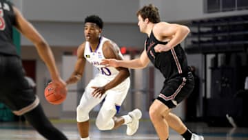FORT MYERS, FLORIDA - NOVEMBER 27: Ochai Agbaji #30 of the Kansas Jayhawks dribbles the ball as Ryan Daly #1 of the Saint Joseph's Hawks defends during the first half during the Rocket Mortgage Fort Myers Tip-Off at Suncoast Credit Union Arena on November 27, 2020 in Fort Myers, Florida. (Photo by Douglas P. DeFelice/Getty Images)