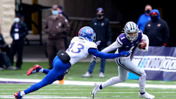 Keenan Garber (1) runs past Kansas football cornerback Ra'Mello Dotson (13). Mandatory Credit: Scott Sewell-USA TODAY Sports