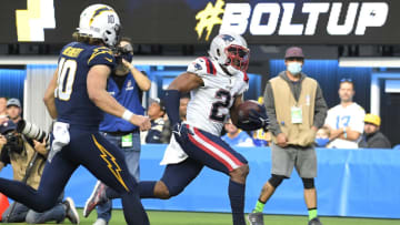 INGLEWOOD, CALIFORNIA - OCTOBER 31: Adrian Phillips #21 of the New England Patriots runs with the ball after intercepting a pass by Justin Herbert #10 of the Los Angeles Chargers in the fourth quarter at SoFi Stadium on October 31, 2021 in Inglewood, California. (Photo by Kevork Djansezian/Getty Images)