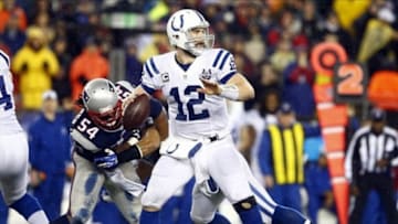 Jan 11, 2014; Foxborough, MA, USA; Indianapolis Colts quarterback Andrew Luck (12) throws a pass against the New England Patriots in the first half during the 2013 AFC divisional playoff football game at Gillette Stadium. Mandatory Credit: David Butler II-USA TODAY Sports