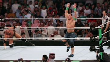 John Cena (R) competes with Triple H (L) during the World Wrestling Entertainment (WWE) Greatest Royal Rumble event in the Saudi coastal city of Jeddah on April 27, 2018. (Photo by STRINGER / AFP) (Photo credit should read STRINGER/AFP/Getty Images)