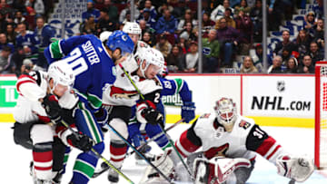 VANCOUVER, BC - JANUARY 16: Arizona Coyotes Goalie Adin Hill (31) reaches for the puck after a shot from Vancouver Canucks Right Wing Brandon Sutter (20) during their NHL game at Rogers Arena on January 16, 2020 in Vancouver, British Columbia, Canada.(Photo by Devin Manky/Icon Sportswire via Getty Images)
