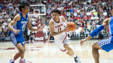 TUSCALOOSA, ALABAMA - FEBRUARY 05: Jahvon Quinerly #13 of the Alabama Crimson Tide drives against Jacob Toppin #0 of the Kentucky Wildcats during the second half of play at Coleman Coliseum on February 05, 2022 in Tuscaloosa, Alabama. (Photo by Michael Chang/Getty Images)