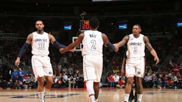 WASHINGTON, DC -  APRIL 22: Mike Scott #30, John Wall #2, and Bradley Beal #3 of the Washington Wizards react to a play against the Toronto Raptors in Game Four of Round One of the 2018 NBA Playoffs on April 22, 2018 at Capital One Arena in Washington, DC. NOTE TO USER: User expressly acknowledges and agrees that, by downloading and or using this Photograph, user is consenting to the terms and conditions of the Getty Images License Agreement. Mandatory Copyright Notice: Copyright 2018 NBAE (Photo by Ned Dishman/NBAE via Getty Images)