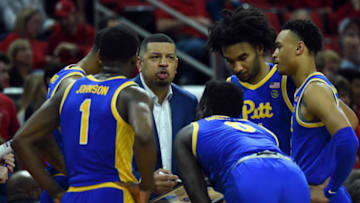 Feb 29, 2020; Raleigh, North Carolina, USA;Pitt Panthers head coach Jeff Capel (center) talks to his players during a timeout in the second half against the North Carolina State Wolfpack at PNC Arena. The Wolfpack won 77-73. Mandatory Credit: Rob Kinnan-USA TODAY Sports