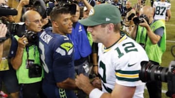 Sep 4, 2014; Seattle, WA, USA; Green Bay Packers quarterback Aaron Rodgers (12) shakes hands with Seattle Seahawks quarterback Russell Wilson (3) following a 36-16 Seahawks victory at CenturyLink Field. Mandatory Credit: Joe Nicholson-USA TODAY Sports