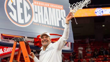 Auburn basketball head coach Bruce Pearl cuts down the net as Auburn Tigers men's basketball celebrates the regular season SEC championship at Neville Arena in Auburn, Ala., on Saturday, March 5, 2022. Auburn Tigers defeated South Carolina Gamecocks 82-71.