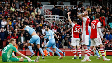 Manchester City's Spanish midfielder Rodri (2L) celebrates with teammates after scoring his team's second goal during the English Premier League football match between Arsenal and Manchester City at the Emirates Stadium in London on January 1, 2022. - - RESTRICTED TO EDITORIAL USE. No use with unauthorized audio, video, data, fixture lists, club/league logos or 'live' services. Online in-match use limited to 120 images. An additional 40 images may be used in extra time. No video emulation. Social media in-match use limited to 120 images. An additional 40 images may be used in extra time. No use in betting publications, games or single club/league/player publications. (Photo by Ian KINGTON / IKIMAGES / AFP) / RESTRICTED TO EDITORIAL USE. No use with unauthorized audio, video, data, fixture lists, club/league logos or 'live' services. Online in-match use limited to 120 images. An additional 40 images may be used in extra time. No video emulation. Social media in-match use limited to 120 images. An additional 40 images may be used in extra time. No use in betting publications, games or single club/league/player publications. / RESTRICTED TO EDITORIAL USE. No use with unauthorized audio, video, data, fixture lists, club/league logos or 'live' services. Online in-match use limited to 120 images. An additional 40 images may be used in extra time. No video emulation. Social media in-match use limited to 120 images. An additional 40 images may be used in extra time. No use in betting publications, games or single club/league/player publications. (Photo by IAN KINGTON/IKIMAGES/AFP via Getty Images)