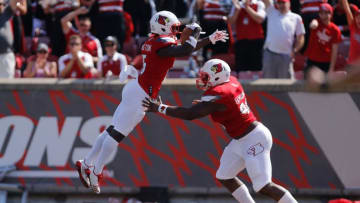 LOUISVILLE, KY - SEPTEMBER 23: Trumaine Washington #15 of the Louisville Cardinals celebrates with Henry Famurewa #96 after returning a interception for a touchdown against the Kent State Golden Flashes during the first half at Papa John's Cardinal Stadium on September 23, 2017 in Louisville, Kentucky. (Photo by Michael Reaves/Getty Images)