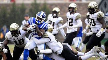 DURHAM, NORTH CAROLINA - NOVEMBER 24: Defensive back Cameron Glenn #2 of the Wake Forest Demon Deacons leads a tackle of running back Deon Jackson #25 of the Duke Blue Devils during their football game at Wallace Wade Stadium on November 24, 2018 in Durham, North Carolina. (Photo by Mike Comer/Getty Images)