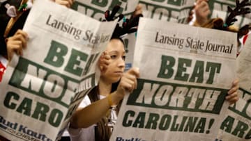 EAST LANSING, MI - DECEMBER 04: Fans look at newspapers while the North Carolina Tar Heels starting lineup is introduced prior to playing the Michigan State Spartans at the Jack T. Breslin Student Events Center on December 4, 2013 in East Lansing, Michigan. North Carolina won the game 79-65. (Photo by Gregory Shamus/Getty Images)