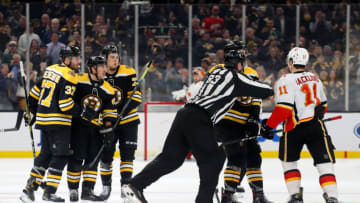 BOSTON, MASSACHUSETTS - FEBRUARY 25: Brad Marchand #63 of the Boston Bruins is separated from Mikael Backlund #11 of the Calgary Flames after Marchand scored a goal during the second period at TD Garden on February 25, 2020 in Boston, Massachusetts. (Photo by Maddie Meyer/Getty Images)