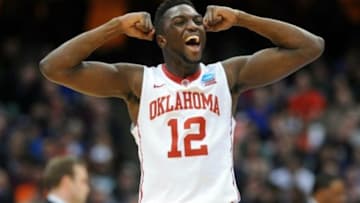 Mar 27, 2015; Syracuse, NY, USA; Oklahoma Sooners forward Khadeem Lattin (12) reacts after a play during the first half against the Michigan State Spartans in the semifinals of the east regional of the 2015 NCAA Tournament at Carrier Dome. Mandatory Credit: Rich Barnes-USA TODAY Sports