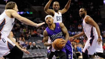 Dec 17, 2013; Charlotte, NC, USA; Sacramento Kings guard Isaiah Thomas (22) drives into the paint against Charlotte Bobcats forward Josh McRoberts (11) guard Kemba Walker (15) and center Al Jefferson (25) during the first half of the game at Time Warner Cable Arena. Mandatory Credit: Sam Sharpe-USA TODAY Sports
