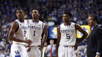 Dec 21, 2013; Lexington, KY, USA; Kentucky Wildcats guard Aaron Harrison (2), guard James Young (1), guard Andrew Harrison (5) and head coach John Calipari huddle during a time in the game against the Belmont Bruins in the second half at Rupp Arena. Kentucky defeated Belmont 93-80. Mandatory Credit: Mark Zerof-USA TODAY Sports