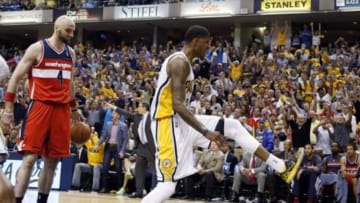 May 7, 2014; Indianapolis, IN, USA; Indiana Pacers forward Paul George (24) reacts after dunking against Washington Wizards center Marcin Gortat (4) in game two of the second round of the 2014 NBA Playoffs at Bankers Life Fieldhouse. Indiana defeats Washington 86-82. Mandatory Credit: Brian Spurlock-USA TODAY Sports