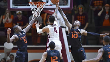 Mar 5, 2016; Blacksburg, VA, USA; Miami Hurricanes guard Davon Reed (5) and guard Sheldon McClellan (10) defend the shot attempt of Virginia Tech Hokies guard Seth Allen (4) in the first half at Cassell Coliseum. Mandatory Credit: Michael Shroyer-USA TODAY Sports