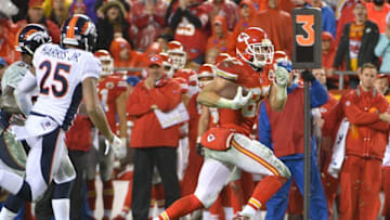 Dec 25, 2016; Kansas City, MO, USA; Kansas City Chiefs tight end Travis Kelce (87) runs the ball as Denver Broncos cornerback Chris Harris (25) defends during the second half at Arrowhead Stadium. The Chiefs won 33-10. Mandatory Credit: Denny Medley-USA TODAY Sports