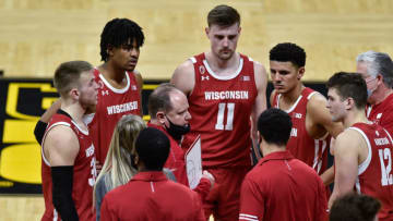 Mar 7, 2021; Iowa City, Iowa, USA; Wisconsin Badgers head coach Greg Gard talks with guard Trevor Anderson (12) and guard Brad Davison (left) and forward Micah Potter (11) late in the game during the second half against the Iowa Hawkeyes at Carver-Hawkeye Arena. Mandatory Credit: Jeffrey Becker-USA TODAY Sports