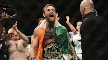 Jul 11, 2015; Las Vegas, NV, USA; Conor McGregor (blue gloves) celebrates after defeating Chad Mendes (not pictured) during their interim featherweight title bout during UFC 189 at MGM Grand Garden Arena. McGregor won via second round TKO. Mandatory Credit: Joe Camporeale-USA TODAY Sports