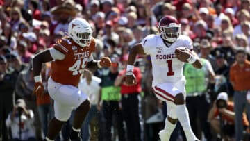 Oct 12, 2019; Dallas, TX, USA; Oklahoma Sooners quarterback Jalen Hurts (1) runs past Texas Longhorns defensive lineman Ta'Quon Graham (49) during the second half at the Cotton Bowl. Mandatory Credit: Kevin Jairaj-USA TODAY Sports