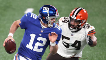 EAST RUTHERFORD, NEW JERSEY - DECEMBER 20: Colt McCoy #12 of the New York Giants scrambles ahead of Olivier Vernon #54 of the Cleveland Browns during the second quarter of a game at MetLife Stadium on December 20, 2020 in East Rutherford, New Jersey. (Photo by Al Bello/Getty Images)