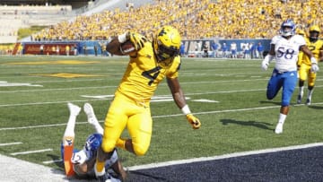 MORGANTOWN, WV - OCTOBER 06: Leddie Brown #4 of the West Virginia Mountaineers runs into the end zone for a 15-yard touchdown after catching a pass against the Kansas Jayhawks in the first quarter of the game at Mountaineer Field on October 6, 2018 in Morgantown, West Virginia. (Photo by Joe Robbins/Getty Images)