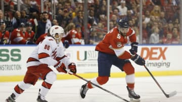 SUNRISE, FLORIDA - OCTOBER 08: Aaron Ekblad #5 of the Florida Panthers battles with Teuvo Teravainen #86 of the Carolina Hurricanes for control of the puck during the first period at BB&T Center on October 08, 2019 in Sunrise, Florida. (Photo by Michael Reaves/Getty Images)