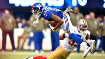 EAST RUTHERFORD, NJ - NOVEMBER 16: Eric Reid #35 of the San Francisco 49ers tackles Odell Beckham #13 of the New York Giants in the fourth quarter at MetLife Stadium on November 16, 2014 in East Rutherford, New Jersey. (Photo by Al Bello/Getty Images)