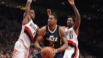 Oct 3, 2016; Portland, OR, USA; Utah Jazz forward Derrick Favors (15) drives to the basket against Portland Trail Blazers forward Maurice Harkless (4) and forward Ed Davis (17) during the third quarter at the Moda Center at the Rose Quarter. Mandatory Credit: Steve Dykes-USA TODAY Sports