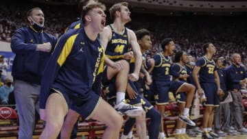 BLOOMINGTON, IN - JANUARY 23: Members of the Michigan Wolverines bench celebrate during the second half against the Indiana Hoosiers at Simon Skjodt Assembly Hall on January 23, 2022 in Bloomington, Indiana. (Photo by Michael Hickey/Getty Images)